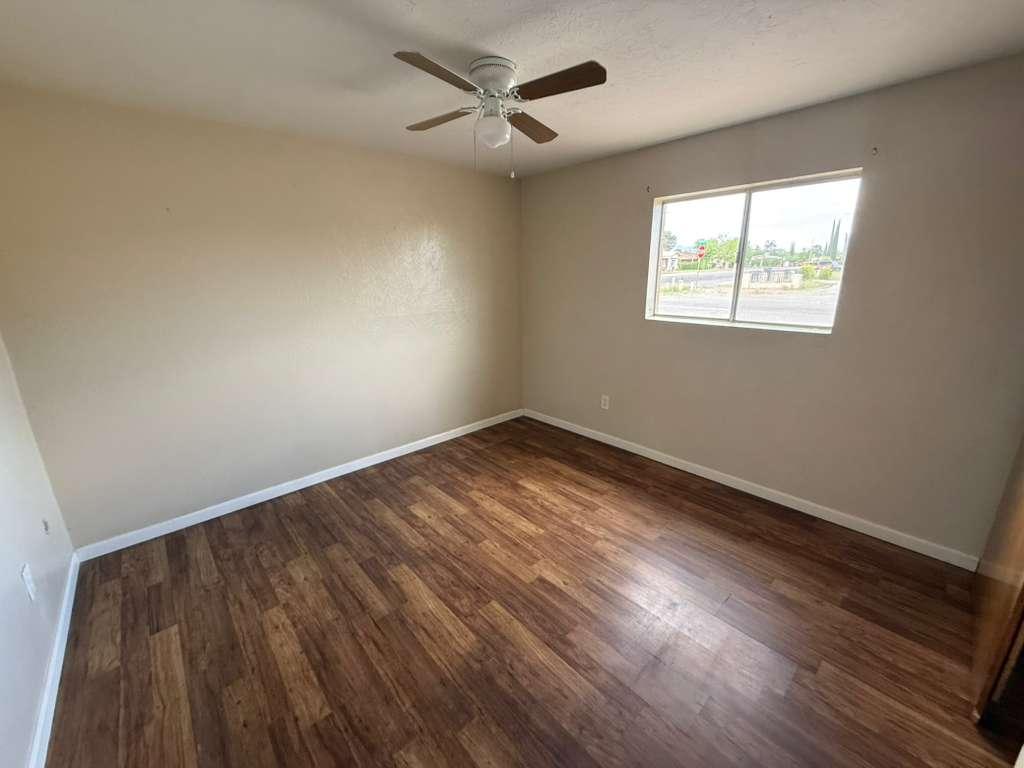 1955 East 8th Street, Unit 1 Douglas, AZ 85607 - Photo 11 of 16 wooden floor in an empty room with a window