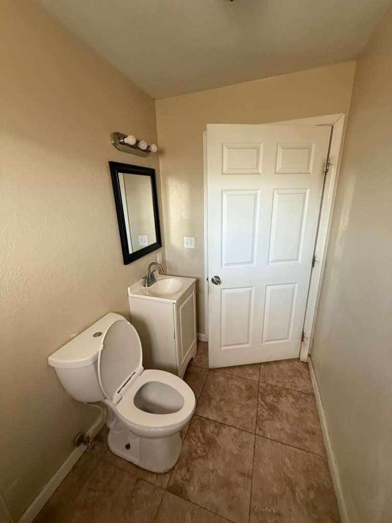 1955 East 8th Street, Unit 1 Douglas, AZ 85607 - Photo 12 of 16 a white toilet sitting next to a bathroom sink