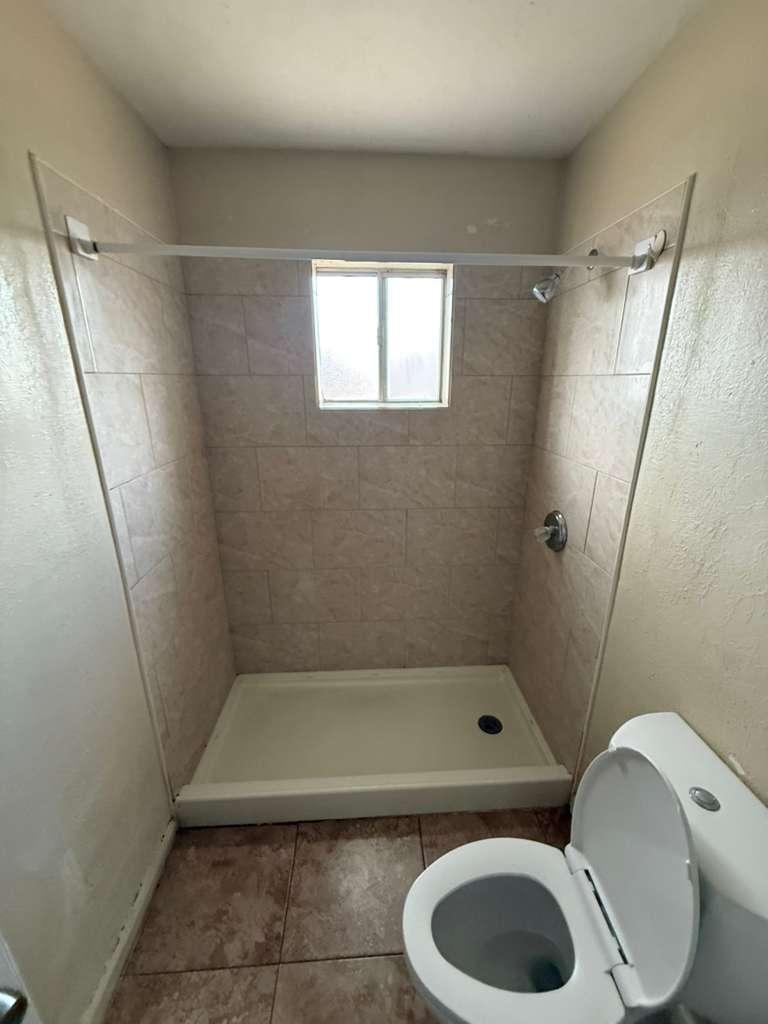 1955 East 8th Street, Unit 1 Douglas, AZ 85607 - Photo 14 of 16 a bathroom with a toilet and a shower