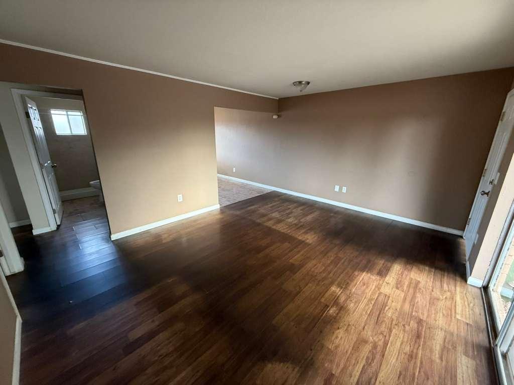 1955 East 8th Street, Unit 1 Douglas, AZ 85607 - Photo 2 of 16 wooden floor in an empty room with a window