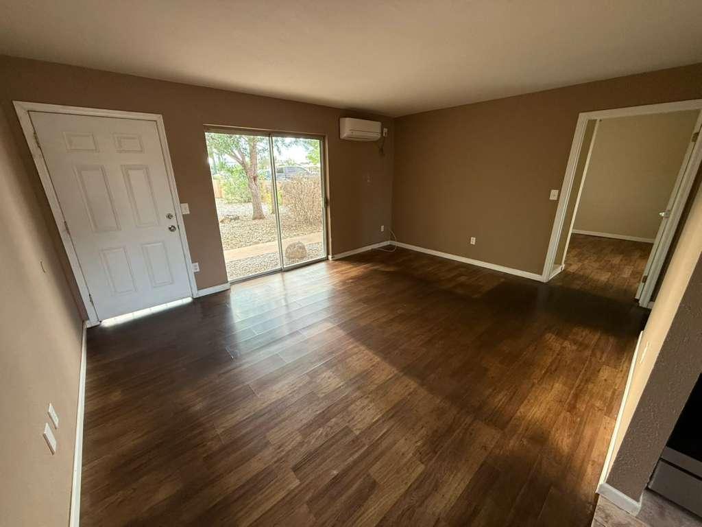 1955 East 8th Street, Unit 1 Douglas, AZ 85607 - Photo 3 of 16 a view of an empty room with wooden floor and a window