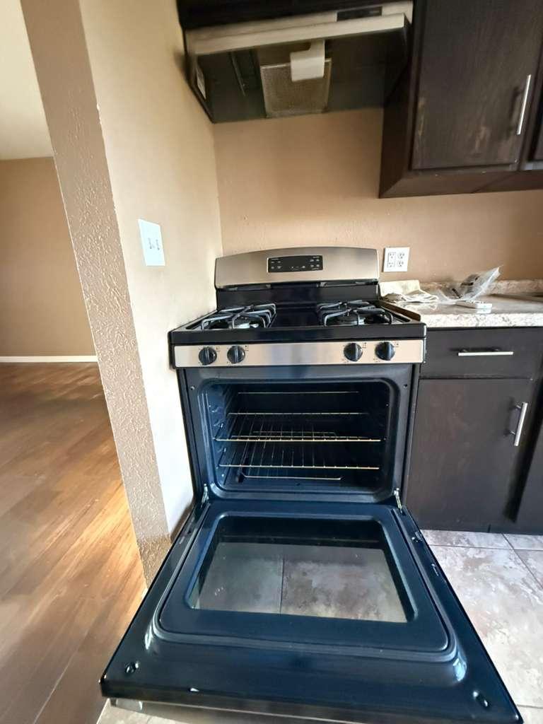 1955 East 8th Street, Unit 1 Douglas, AZ 85607 - Photo 5 of 16 a stove top oven sitting inside of a kitchen
