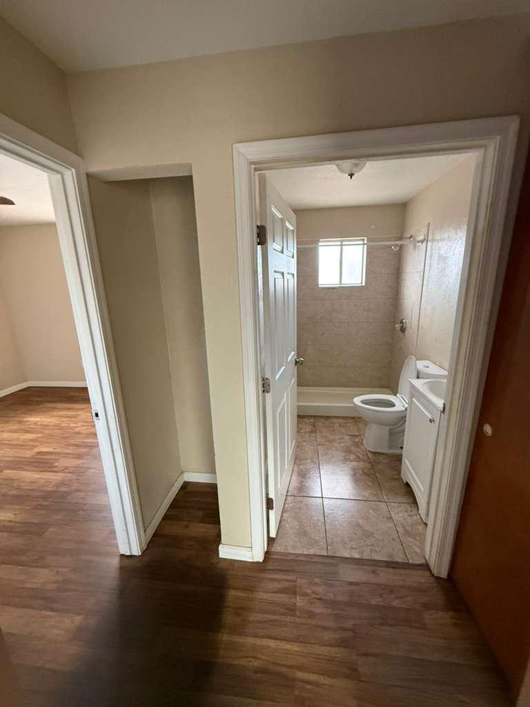 1955 East 8th Street, Unit 1 Douglas, AZ 85607 - Photo 8 of 16 a view of a hallway with wooden floor and a living room