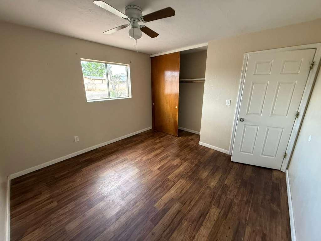 1955 East 8th Street, Unit 1 Douglas, AZ 85607 - Photo 10 of 16 a view of an empty room with wooden floor and a window