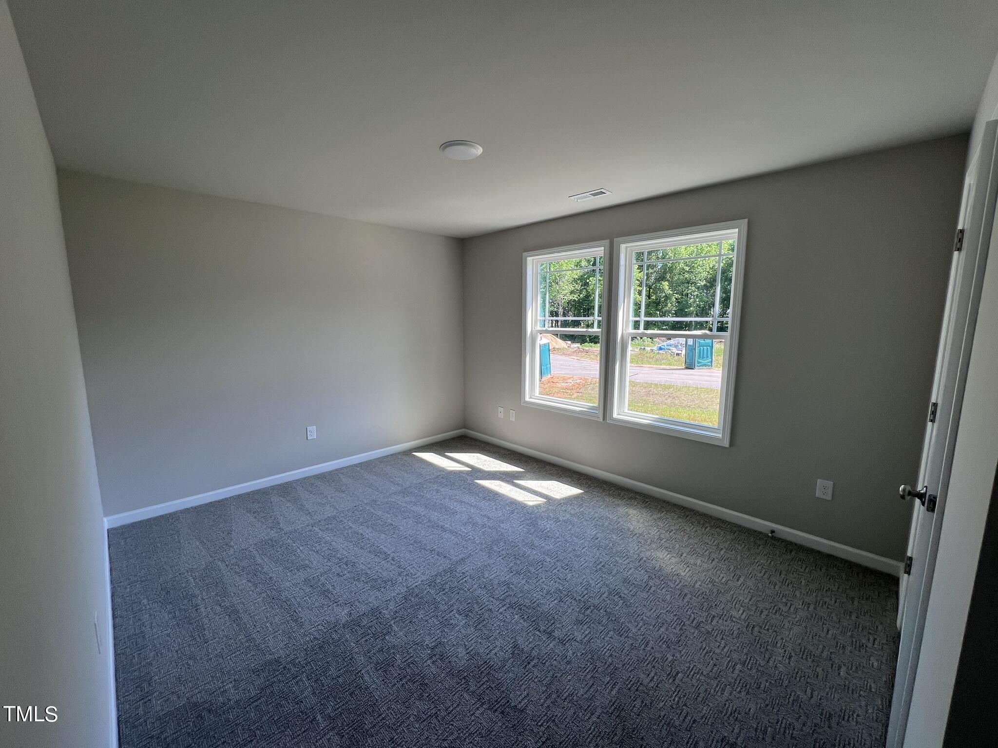 339 Bushel Lane Willow Spring, NC 27592 - Photo 13 of 18 an empty room with a empty space and a window