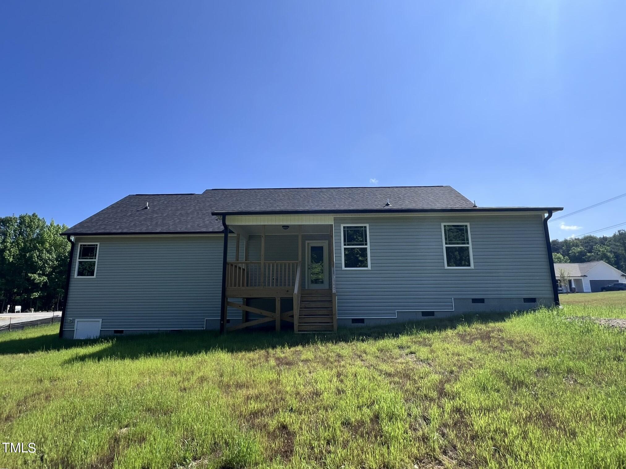 339 Bushel Lane Willow Spring, NC 27592 - Photo 17 of 18 a backyard of a house with lots of green space