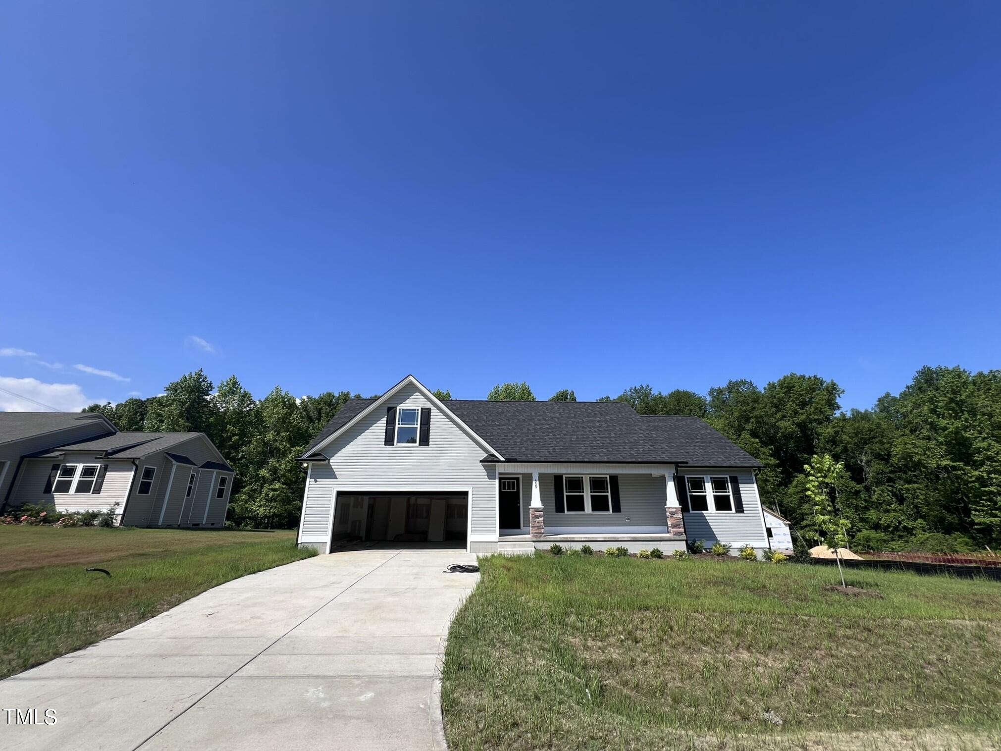 339 Bushel Lane Willow Spring, NC 27592 - Photo 2 of 18 a front view of a house with a yard