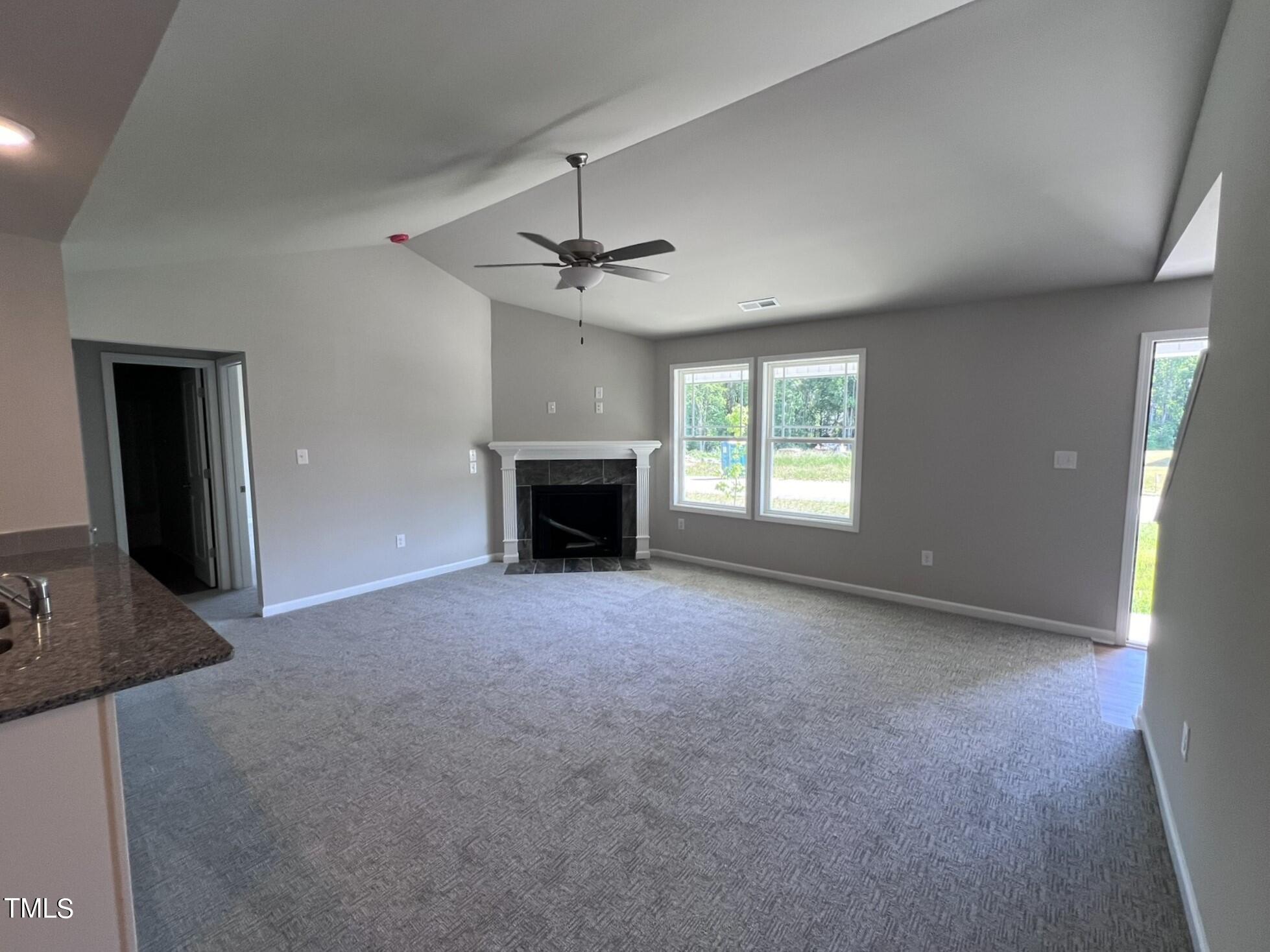 339 Bushel Lane Willow Spring, NC 27592 - Photo 4 of 18 an empty room with windows and fireplace