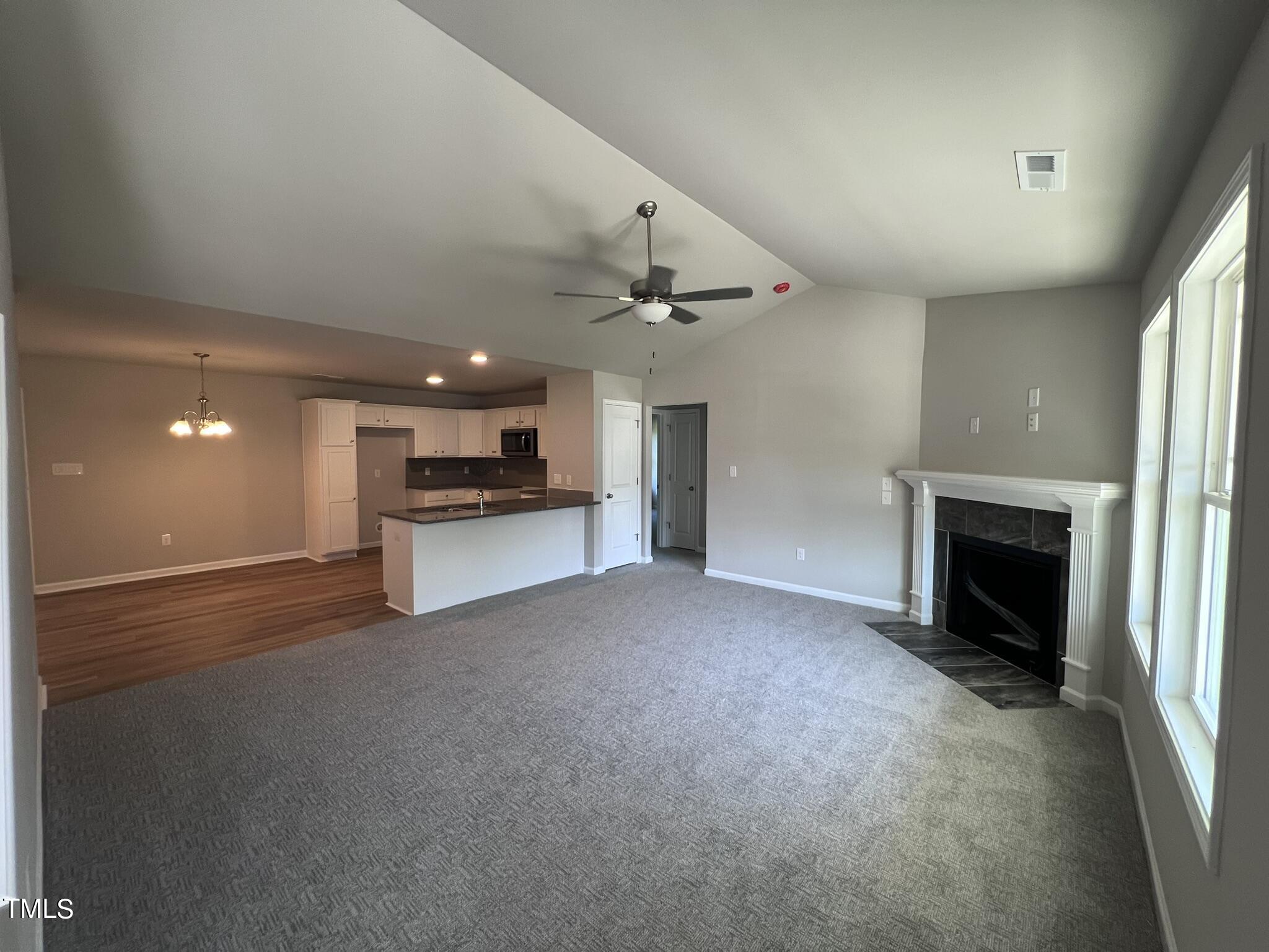 339 Bushel Lane Willow Spring, NC 27592 - Photo 5 of 18 a view of an empty room with a fireplace and a window