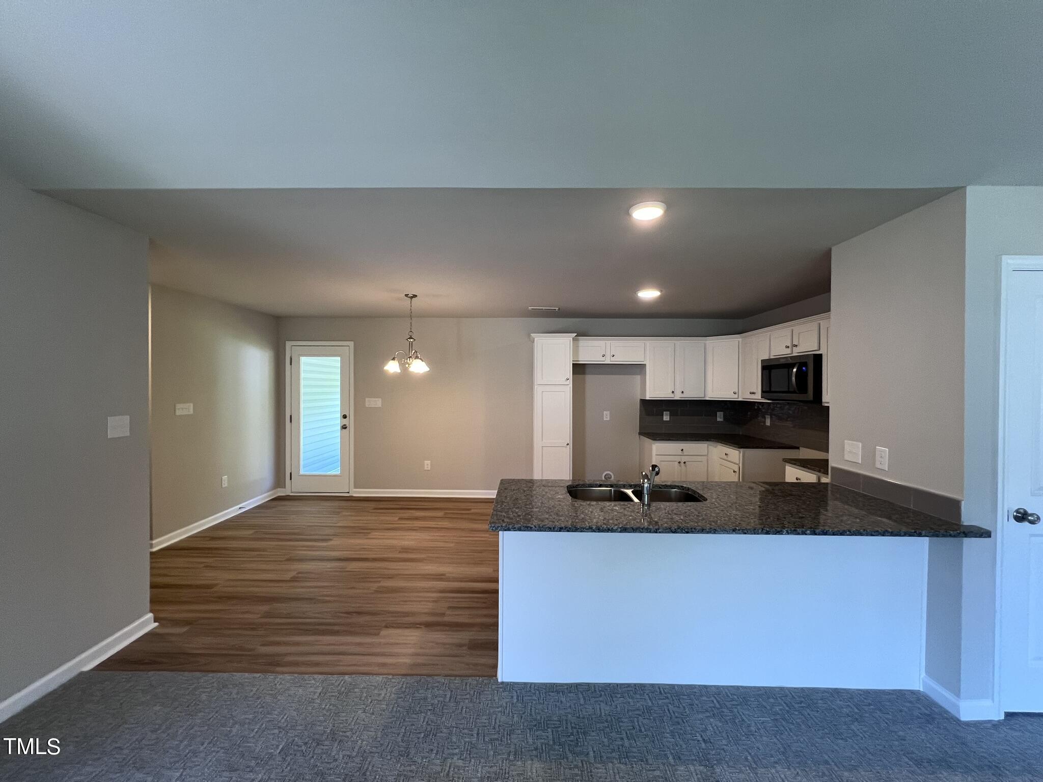 339 Bushel Lane Willow Spring, NC 27592 - Photo 6 of 18 a kitchen with kitchen island a sink stainless steel appliances and cabinets