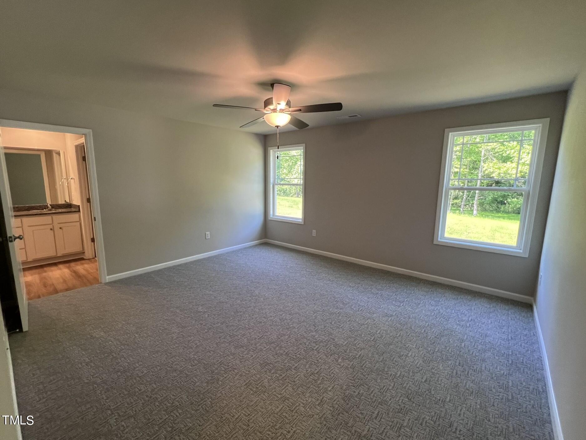 339 Bushel Lane Willow Spring, NC 27592 - Photo 9 of 18 an empty room with windows and fan