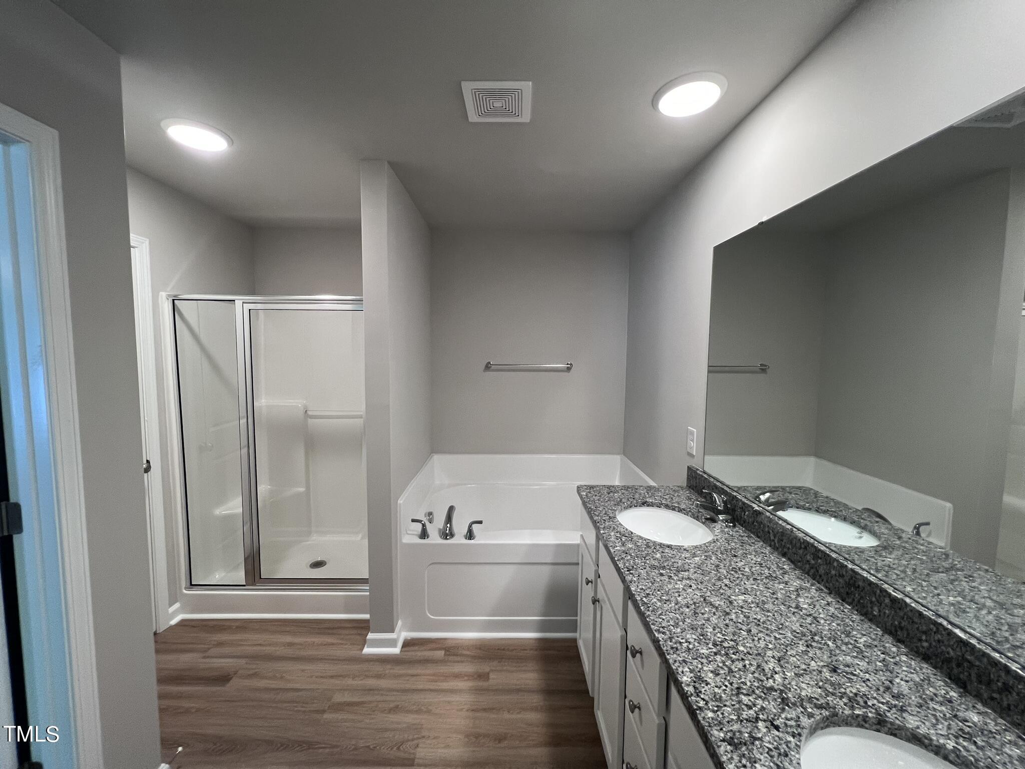 339 Bushel Lane Willow Spring, NC 27592 - Photo 10 of 18 a bathroom with a granite countertop sink and a mirror