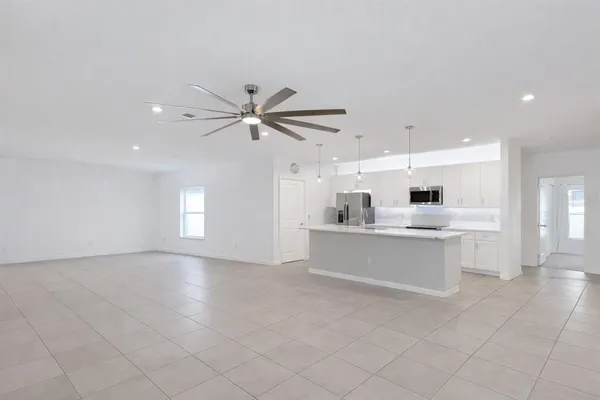 a large white kitchen with a white countertops a sink and dishwasher