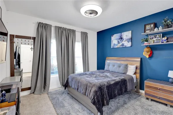 a bedroom with a bed and a window