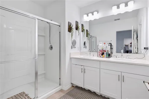 a bathroom with a shower sink and mirror