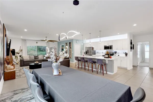 a large kitchen with a table and chairs