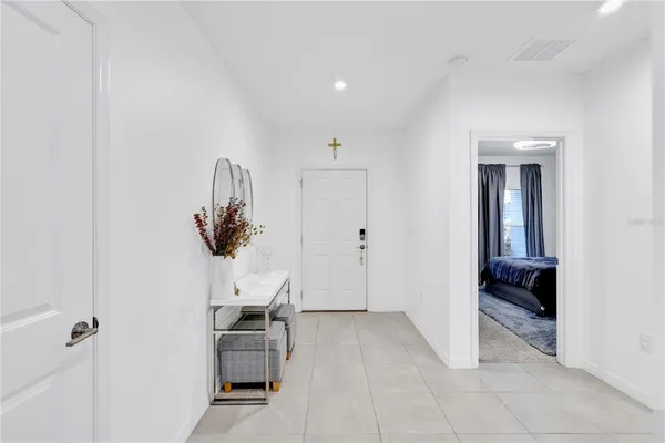 a view of a hallway with entryway and furniture