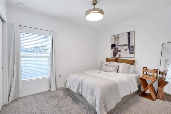 a bedroom with a bed and a window
