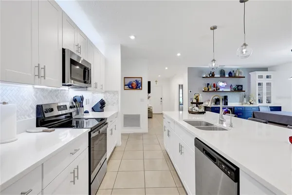 a kitchen that has a lot of cabinets in it and white cabinets