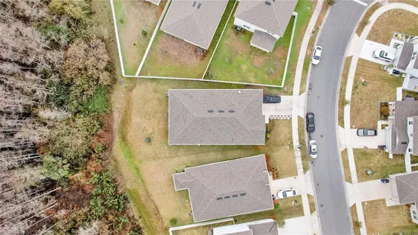 an aerial view of residential house with outdoor space and parking