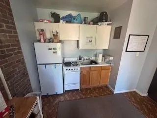 a kitchen with sink refrigerator and stove