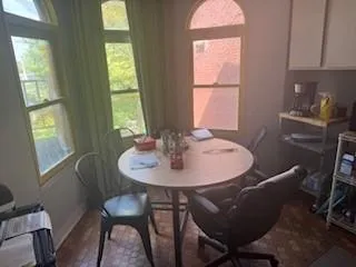 a view of a dining room with furniture and window