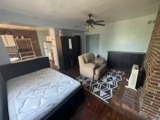 a bedroom with furniture and wooden floor