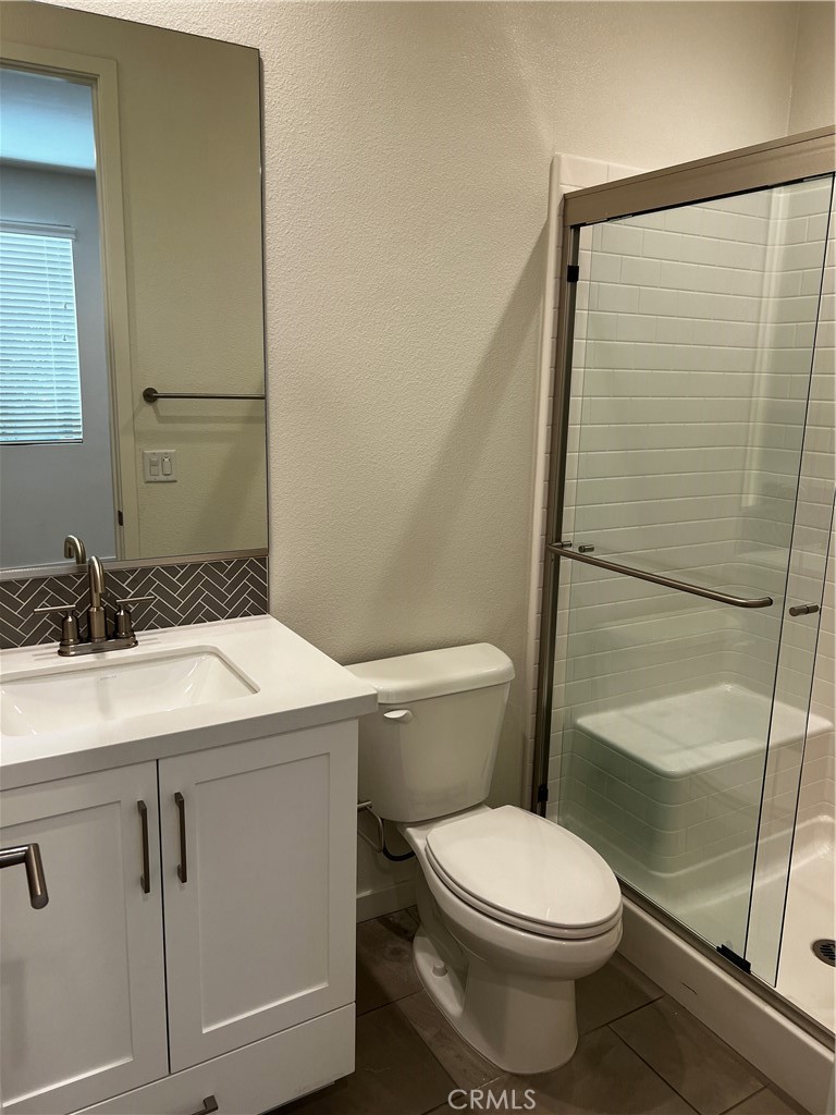 155 Hideaway Loop Mission Viejo, CA 92692 - Photo 15 of 18 a bathroom with a granite countertop sink toilet and shower