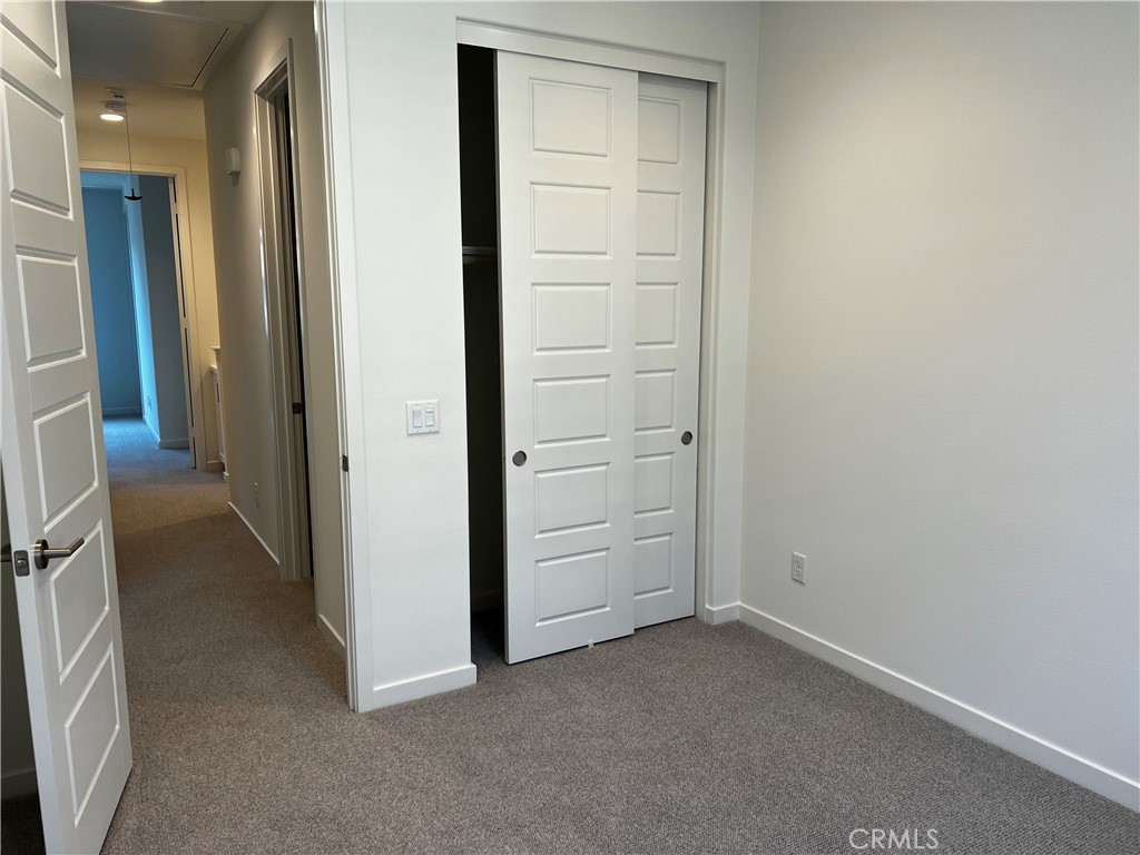 155 Hideaway Loop Mission Viejo, CA 92692 - Photo 4 of 18 an empty room with a hallway and closet