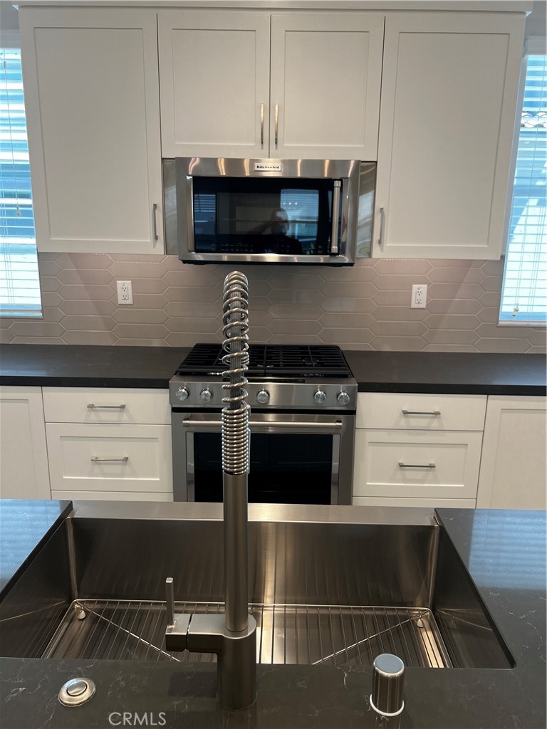 155 Hideaway Loop Mission Viejo, CA 92692 - Photo 7 of 18 a kitchen with a stove and a microwave