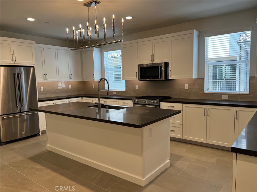 155 Hideaway Loop Mission Viejo, CA 92692 - Photo 8 of 18 a kitchen with granite countertop a sink and stainless steel appliances