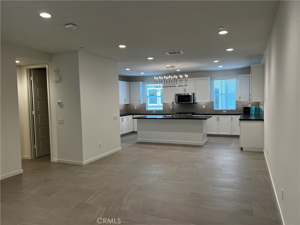 155 Hideaway Loop Mission Viejo, CA 92692 - Photo 9 of 18 a kitchen with stainless steel appliances granite countertop a refrigerator and a stove top oven