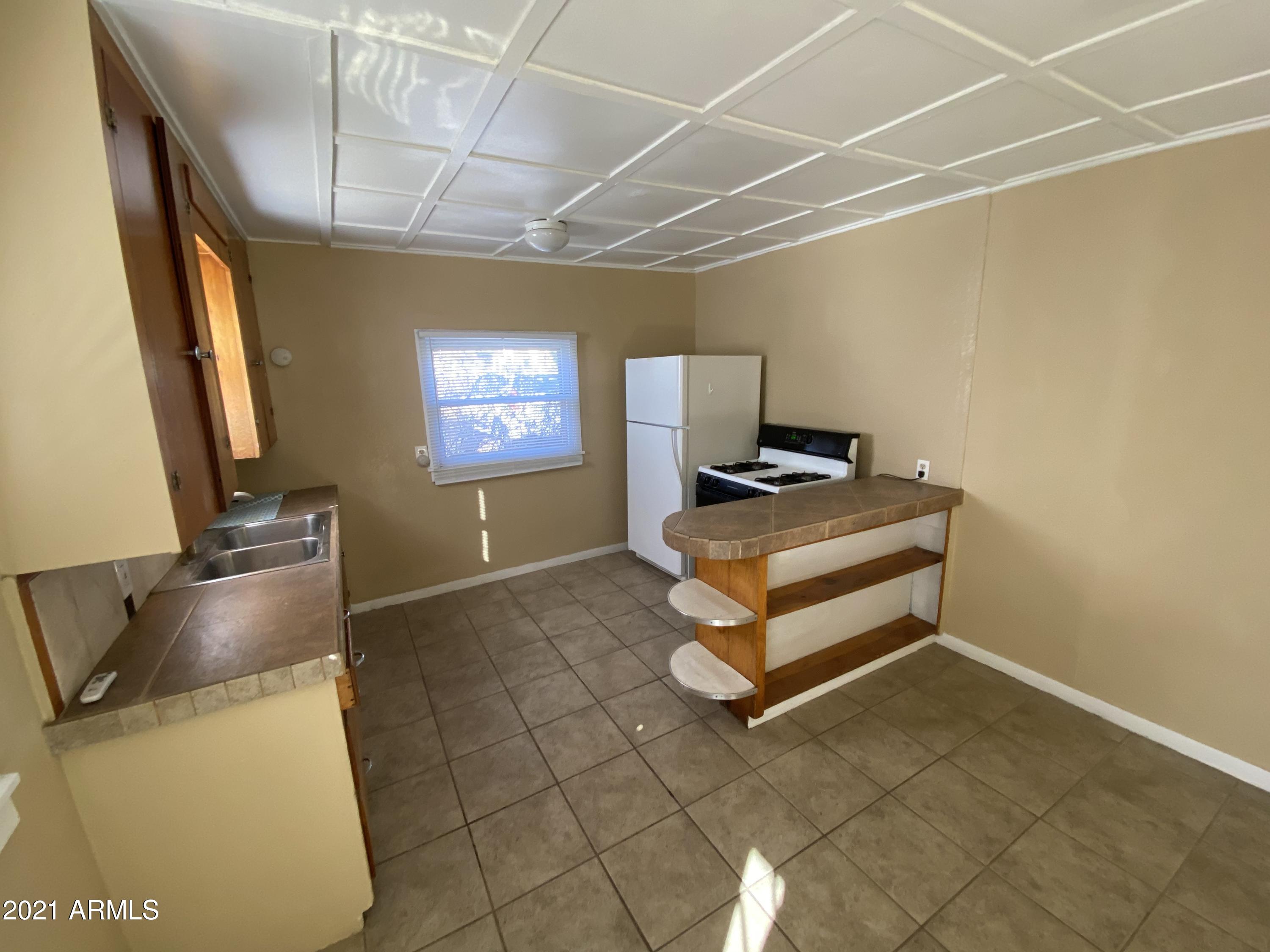 1037 North 25th Street, Unit 2 Phoenix, AZ 85008 - Photo 1 of 18 a room with storage and utility