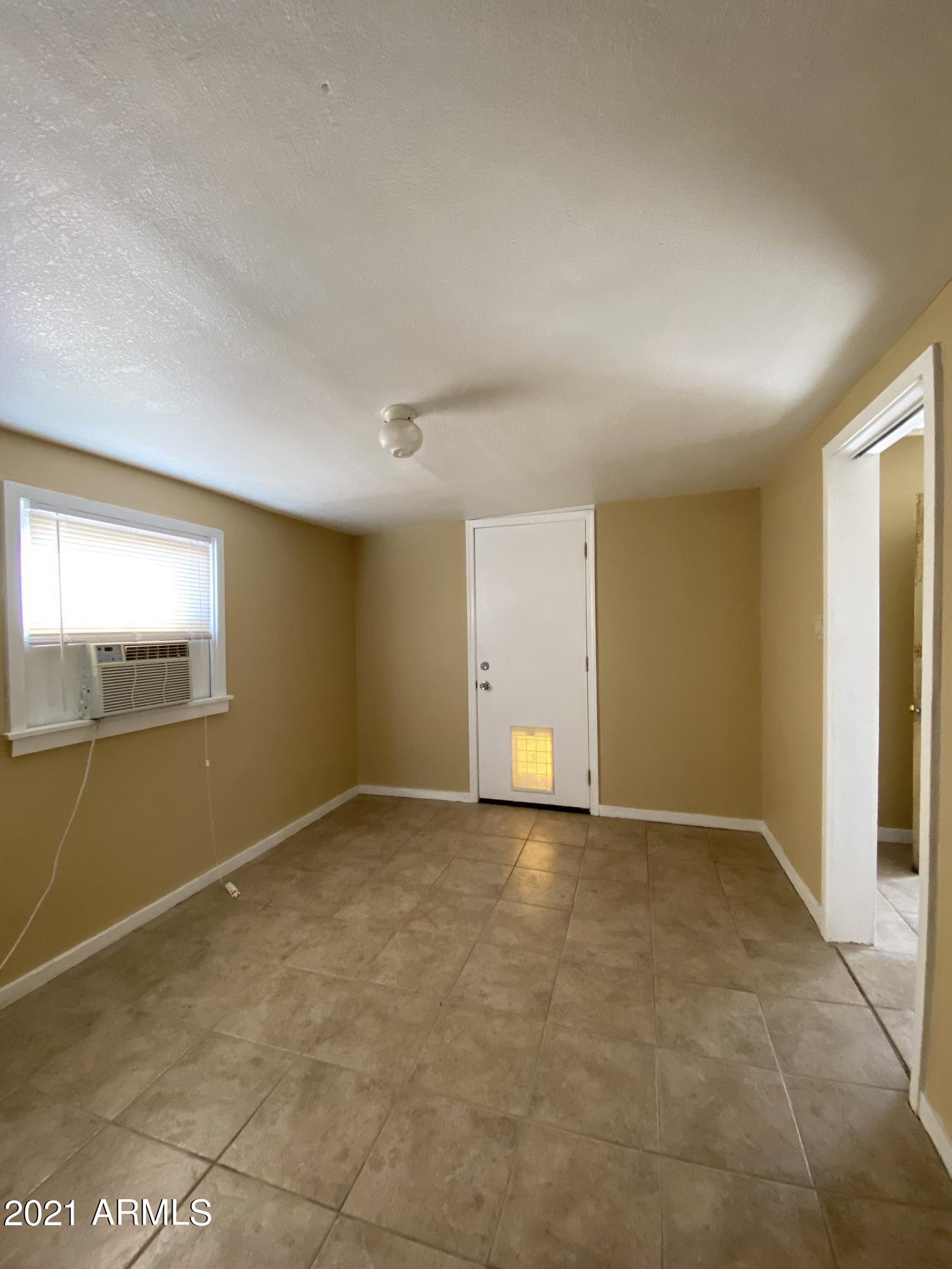 1037 North 25th Street, Unit 2 Phoenix, AZ 85008 - Photo 12 of 18 an empty room with a empty space and windows