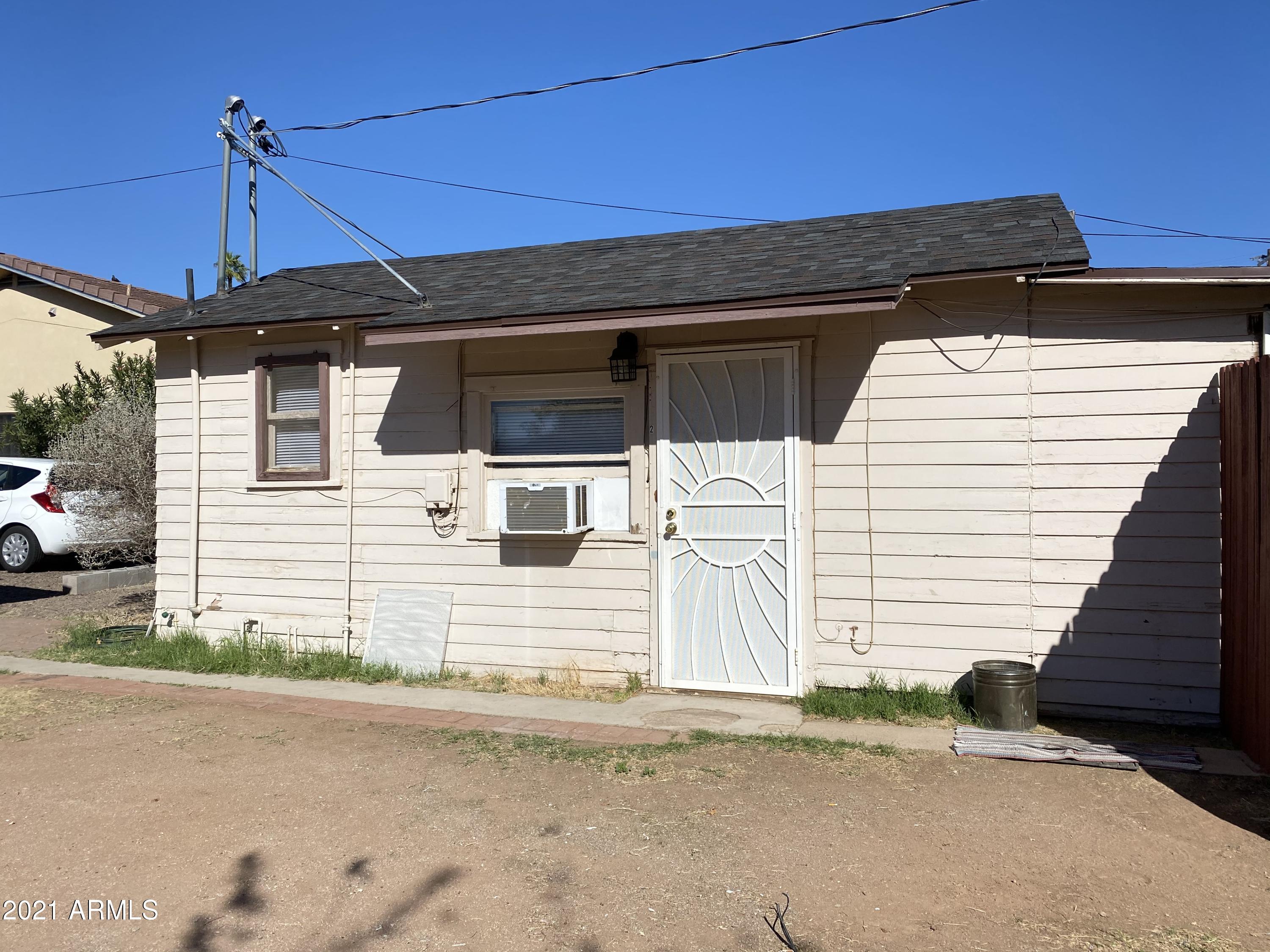 1037 North 25th Street, Unit 2 Phoenix, AZ 85008 - Photo 13 of 18 a front view of a house with a road