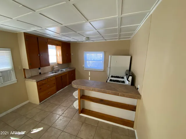 a kitchen with a sink appliances and cabinets