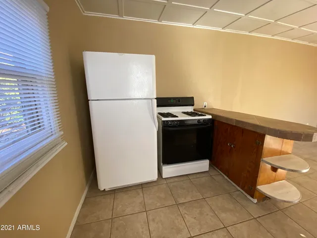 a kitchen with a refrigerator and a stove