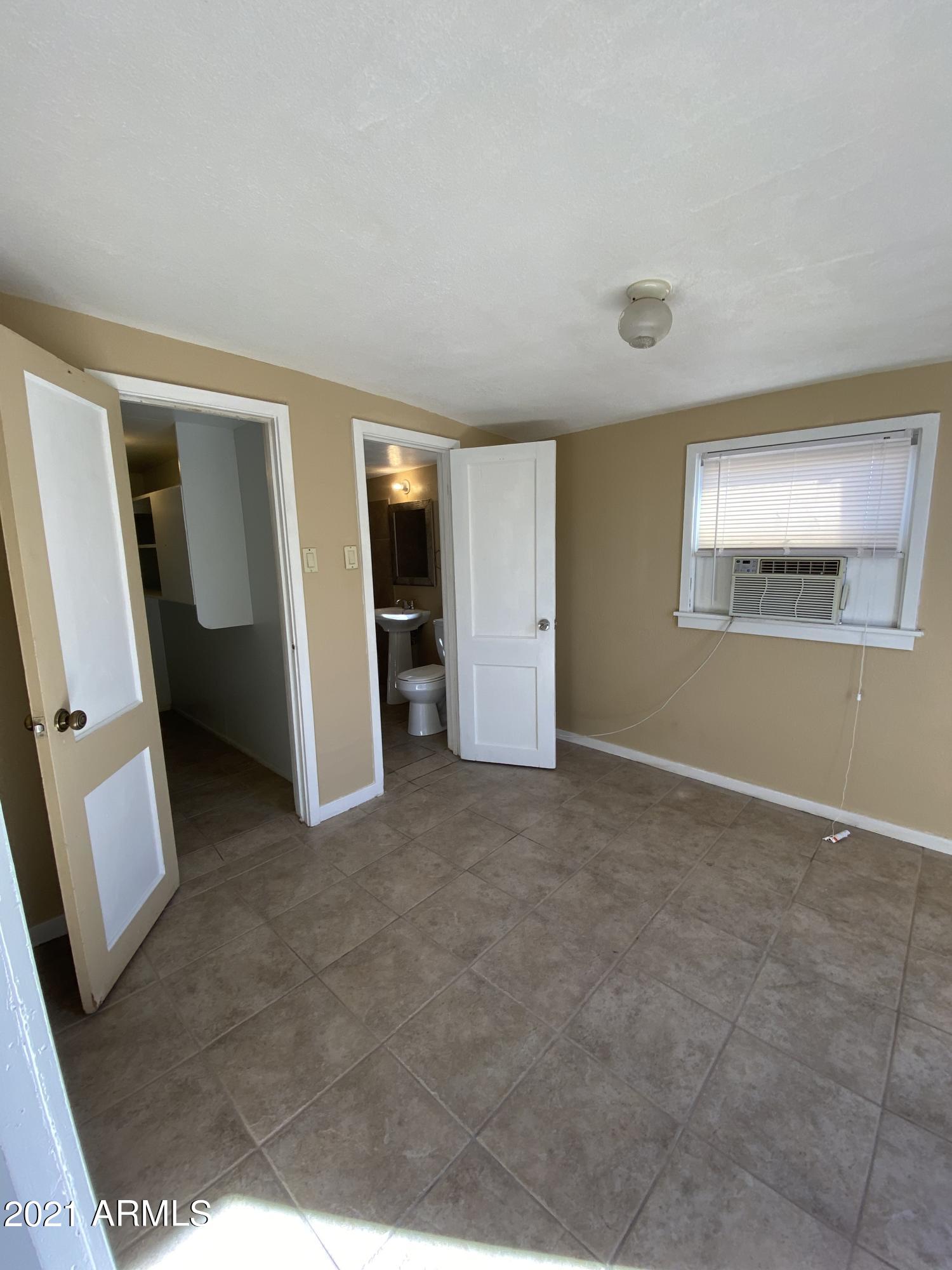 1037 North 25th Street, Unit 2 Phoenix, AZ 85008 - Photo 7 of 18 a view of an empty room with a fireplace