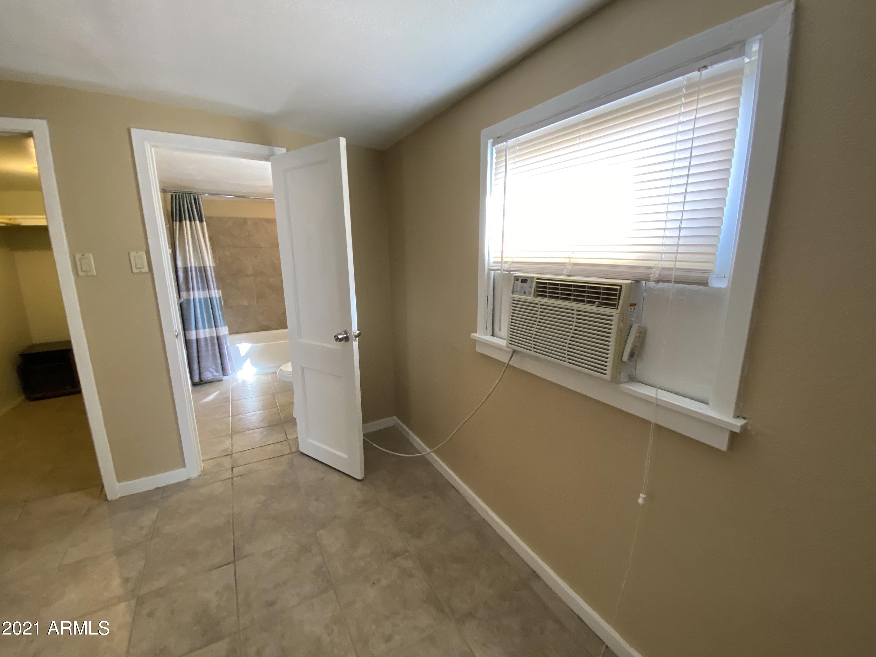 1037 North 25th Street, Unit 2 Phoenix, AZ 85008 - Photo 9 of 18 a view of empty room with windows