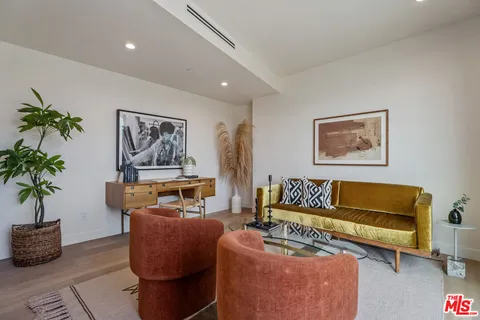 a bedroom with furniture and a potted plant