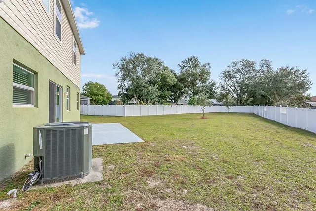 an aerial view of a house with yard swimming pool and mountain view