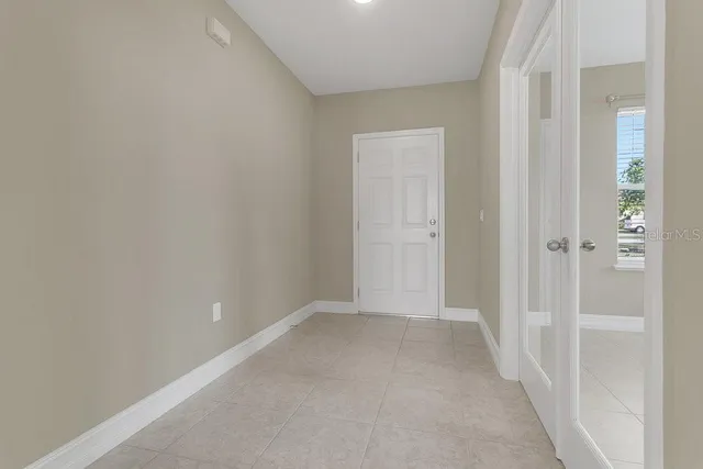 an empty room with windows and closet