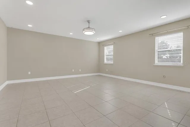 a kitchen with granite countertop a refrigerator and a stove top oven