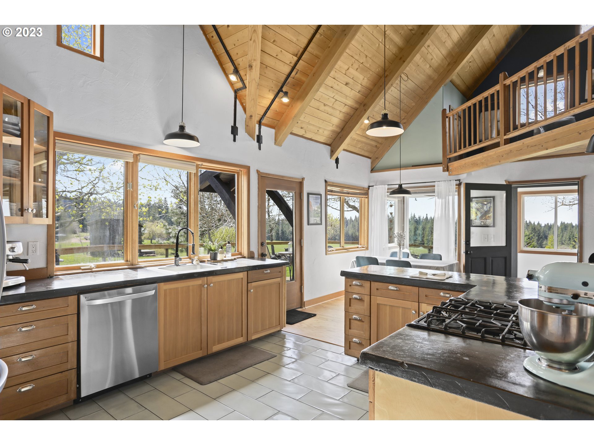 238 Acme Road White Salmon, WA 98672 - Photo 14 of 48 a kitchen with stainless steel appliances kitchen island granite countertop a stove and a sink