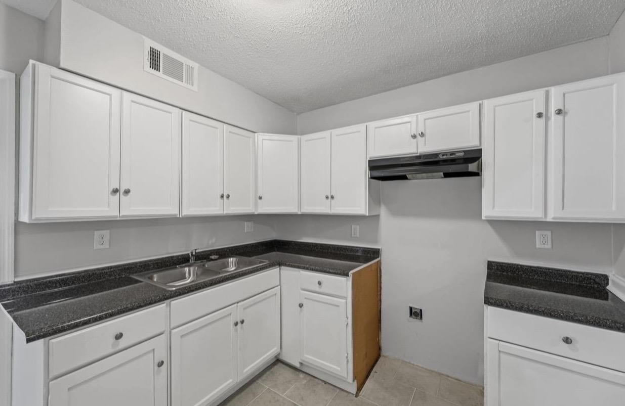 3843 Blue Jay Road Memphis, TN 38116 - Photo 10 of 23 a kitchen with white cabinets and white appliances