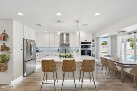 a large kitchen with lots of counter space and furniture
