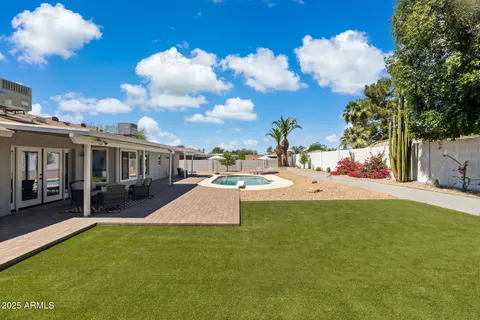 a view of a house with swimming pool and sitting area