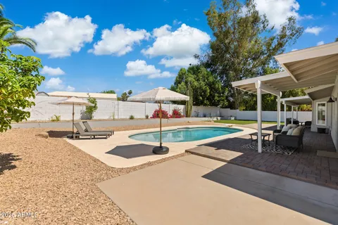 a view of a swimming pool with a yard