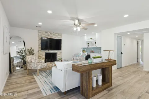 a view of kitchen with stainless steel appliances refrigerator stove microwave and cabinets