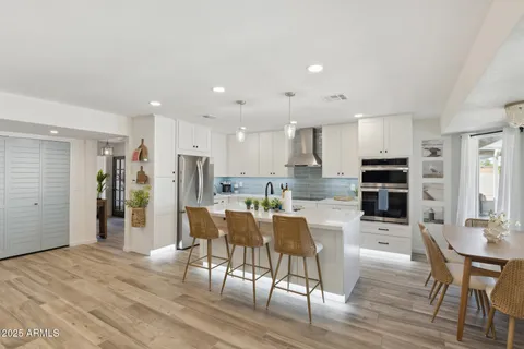 a kitchen with a white cabinets and white appliances